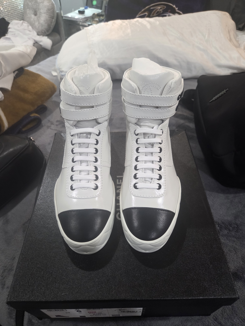 CHANEL White High-Top Sneakers with Black Toe Detail
